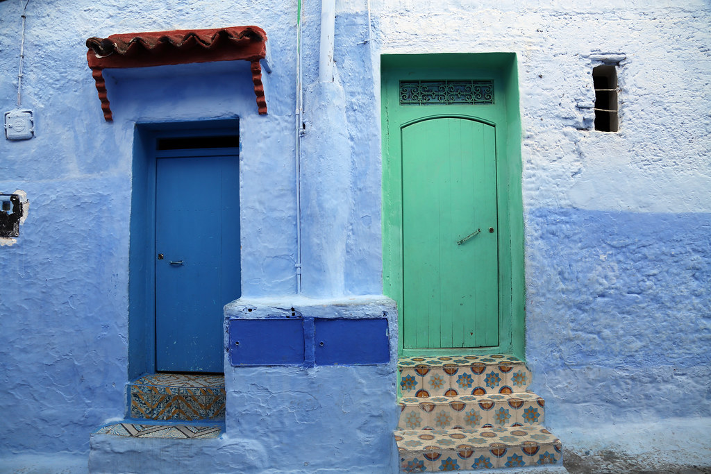 Cobalt blue painted staircase and historic doorways in Chefchaouen Morocco