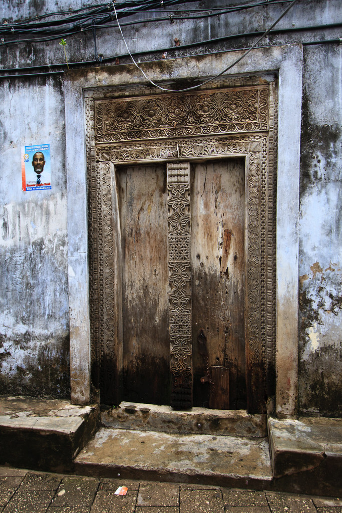 Stone Town historic coral stone alleyway with traditional carved doors in Zanzibar