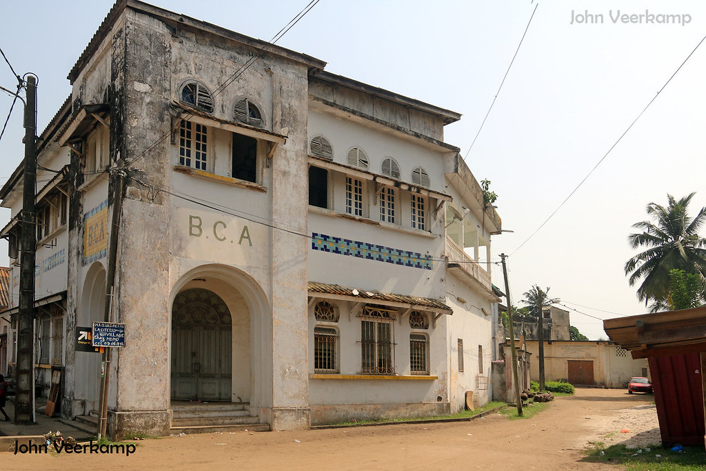 Historic French colonial architecture and palm trees in the historic seaside town of Grand-Bassam, Côte d'Ivoire