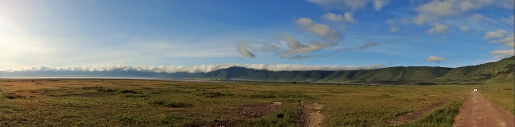 Panoramic view across the volcanic caldera floor and alkaline lake of Ngorongoro Crater in Tanzania.